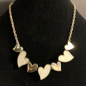 cream colored INC heart necklace with gold tone